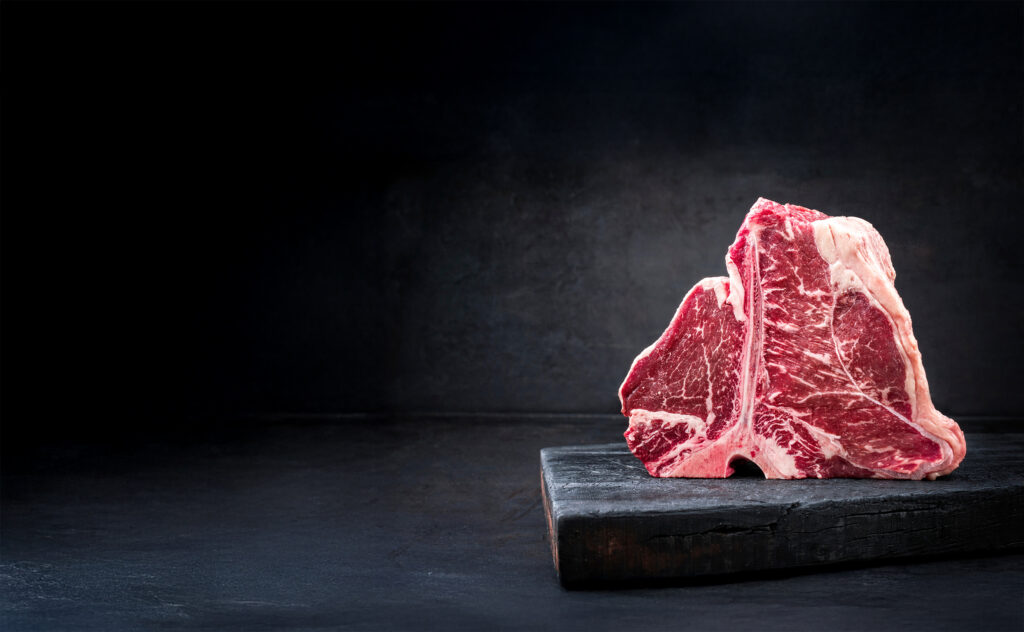 Tender steaks on dark background